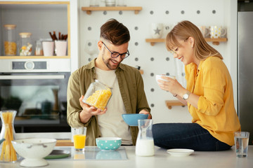 Young couple making breakfast at home. Loving couple enjoying in morning..