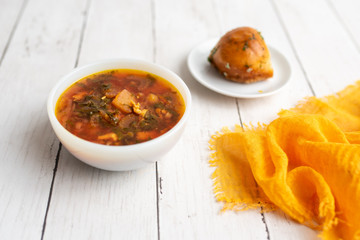 Russian borscht with sorrel and fresh garlic knots pamopushkas. hot soup with egg version. Sorrel soup. 