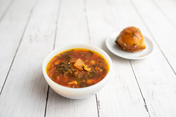 Russian borscht with sorrel and fresh garlic knots pamopushkas. hot soup with egg version. Sorrel soup. 