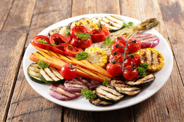 grilled colorful vegetables, aubergine, zucchini, bell pepper, celery, onion, corn with basil