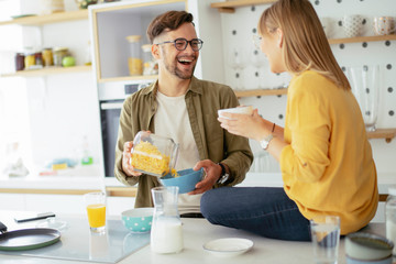 Young couple making breakfast at home. Loving couple enjoying in morning..