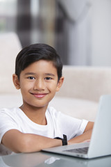 Boy with laptop smiling