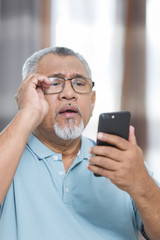Senior man looking at his phone