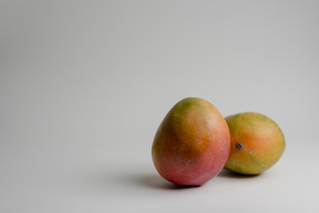 DELICIOUS AND NATURAL PERUVIAN MANGO ON WHITE BACKGROUND