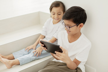 Brother and sister with a digital tablet