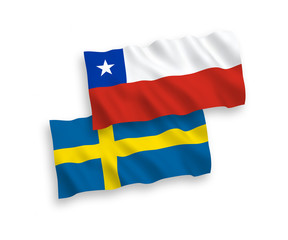 National vector fabric wave flags of Sweden and Chile isolated on white background. 1 to 2 proportion.