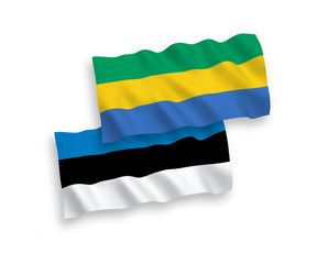 National vector fabric wave flags of Estonia and Gabon isolated on white background. 1 to 2 proportion.
