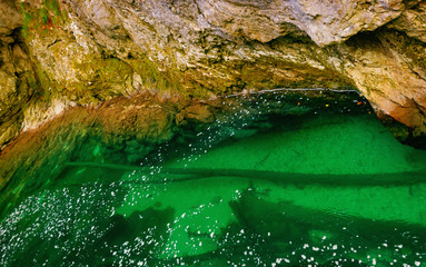 the green water of the mountain and the bridge over the rocks on an autumn day