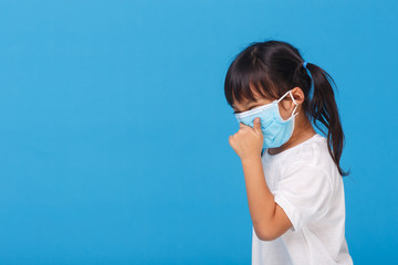 Cute Asian girl wearing mask to prevent the virus PM2.5, Coronavirus, (2019-nCoV) asian little girl feeling unwell and coughing as symptom for cold or pneumonia