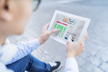 Man buying movie tickets on digital tablet