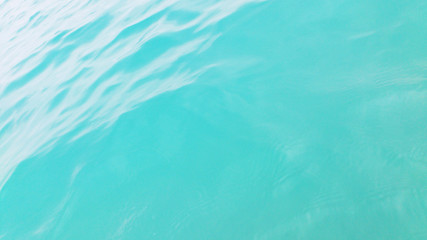 Turquoise background. The surface of the sea water.