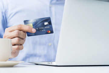 Man holding a credit card for online shopping