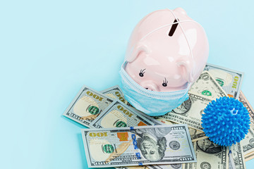 Piggy bank and cash money one hundred dollars bills on blue background. Flat lay, top view, overhead, mockup, template. Concept of Financial crisis after end coronavirus covid-19 pandemic lockdown