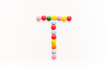 Candies font alphabet. Letter T isolated top view