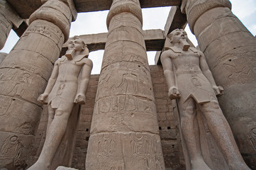Hieroglyphic carvings on ancient egyptian temple columns and statues