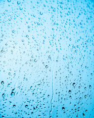 Raindrops on glass against the sky