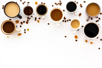 Cups of hot drinks on white table top-down space for text