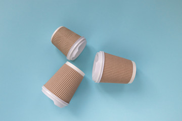 Paper cups of coffee to go on pastel background.