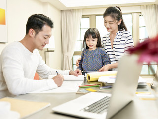 happy asian family with one child staying at home