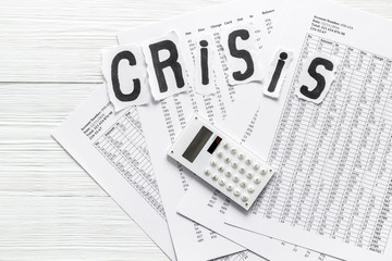 World financial crisis concept - documents, calculator - on white wooden background top view