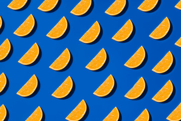 Bright ripe citrus pattern flat lay on blue background 