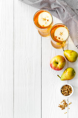 Fruit drinks with apple and pear on white wooden desk from above copy space
