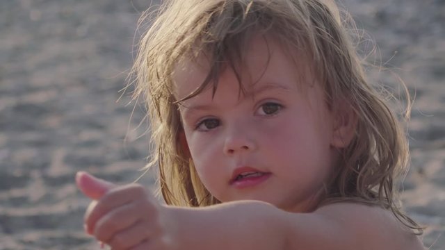 Beautiful little girl on a sandy beach