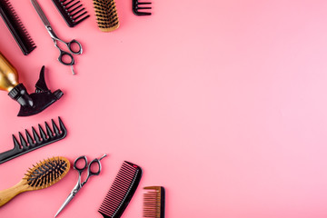 Hairdressing instruments. Combs, scissors on pink table top view frame copy space