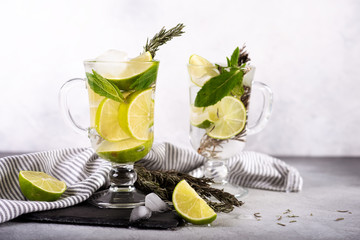 Mojito cocktail with lime and mint in highball glass on a grey stone background Copy space