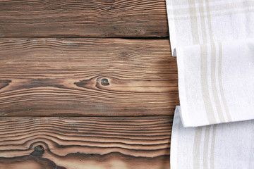 White towel cloth on dark wooden table top background empty space,food advertisemnt backdrop.