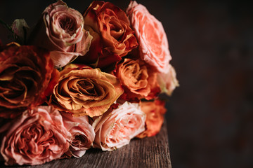 Obraz premium Bouquet with colorful roses on the rustic background. Shallow depth of field. 