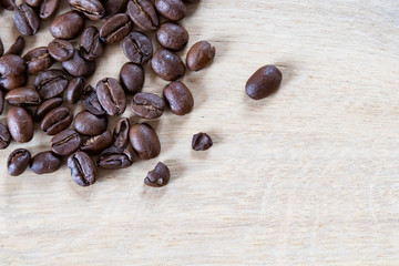Coffee beans on wooden background, oak wood soft light and beans. Coffee background with wooden texture