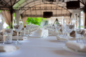 dishes on the table in a restaurant. glasses on the table. wedding party.table setting. table setting for the holiday. birthday celebrations. 