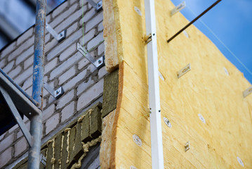 office building under construction. Facing and insulation of walls