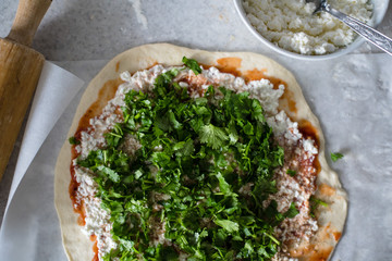 Cooking Khachapuri with cottage cheese and cilantro.