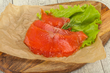 Sliced salmon fillet served rosemary