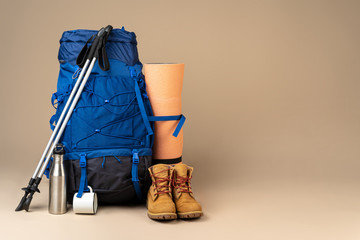 Blue backpack and hiking boots. Mountain gear ready for trip close up