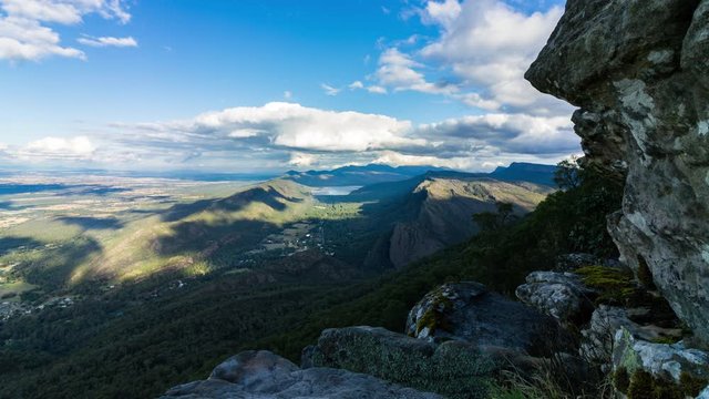 Time lapse of clouds forming over Halls Gap as a mossy rock outcrop reveals at Boroka Lookout in the Grampains National Park, Victoria (Australia)