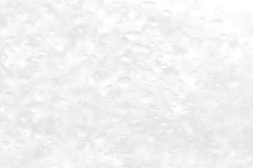 Abstract grey and white circular circle background. Close up of raindrops or water drops on a clear window glass surface. Halftone perspective modern bright art using for a backdrop, wallpaper.