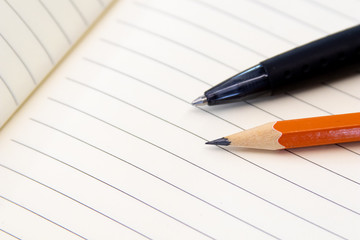 Educational tools, Pencil and pen on notebook with rows. Office and school tools for production. Image for lawyer, business and activities with notes