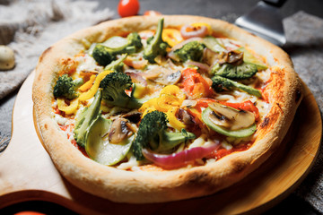 Vegetarian pizza with greens and broccoli, zucchini and pepper. Slimming pizza.
