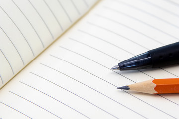Educational tools, Pencil and pen on notebook with rows. Office and school tools for production. Image for lawyer, business and activities with notes
