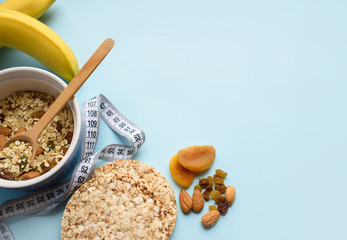 Useful breakfast, proper nutrition, oatmeal, dried fruits, breads, fruits, a centimeter on a light background. Diet. A place for text.