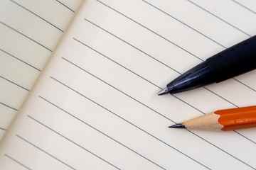 Educational tools, Pencil and pen on notebook with rows. Office and school tools for production. Image for lawyer, business and activities with notes