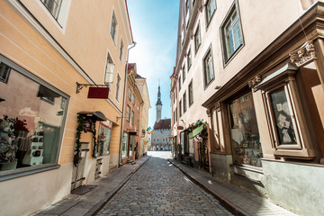Fototapeta na wymiar architecture and urban concept - empty street of Tallinn city old town leading to hall square