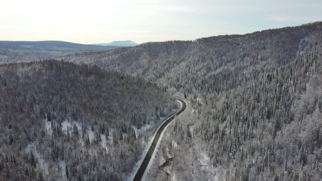 Aerial view of winter trees along a road with snow. Sheregesh, Siberia