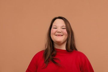 Fototapeta premium Beautiful young girl in a bright red jacket, overweight girl.