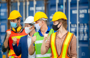 Success and Teamwork Concept, Engineer and worker team wearing protection face mask against coronavirus, Happy business people team celebration with blurred cargo containers background