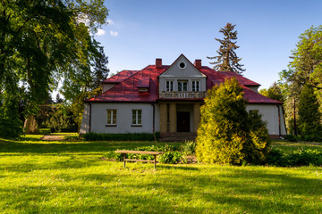 Historic manor in Sedziejowice, Poland surrounded by an old park.