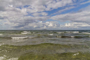 Windy weather on the sea, waves and clouds